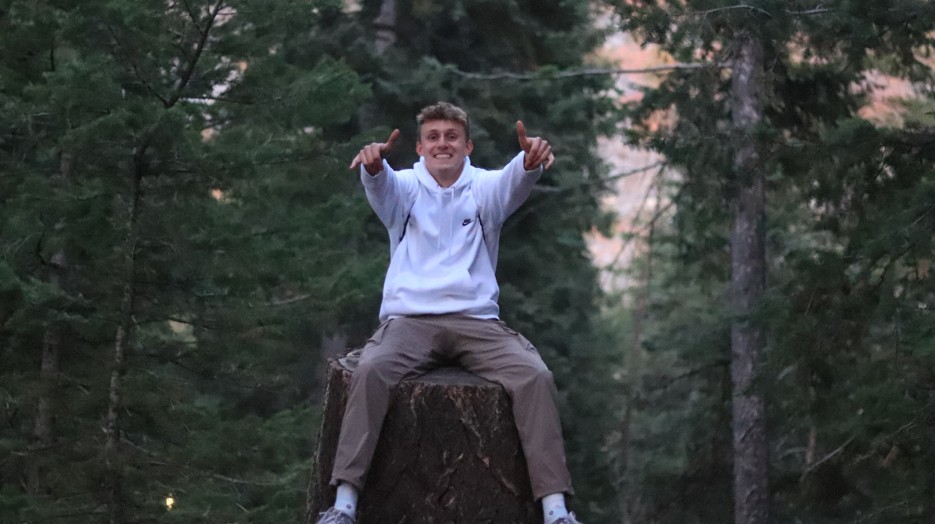 Drew Whimpey on tree stump